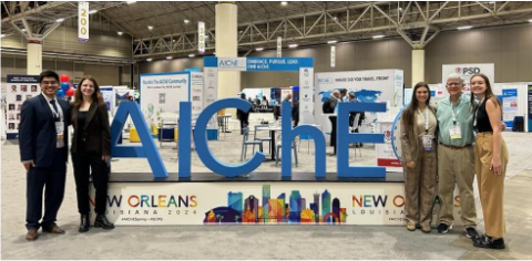 People posing with an AIChE sign