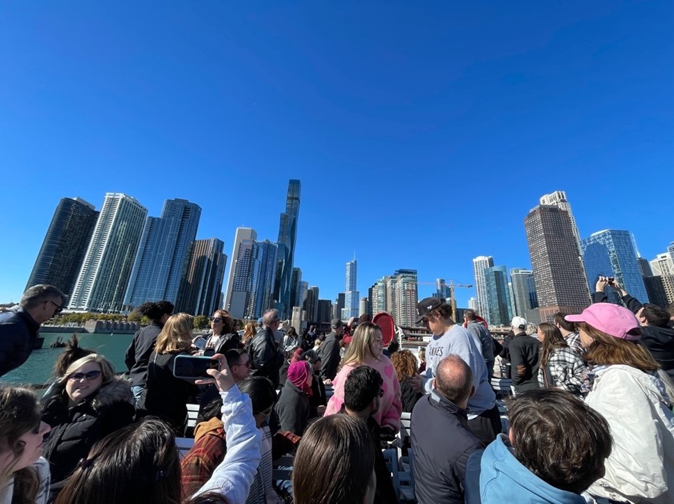 people taking photos of the chicago skyline