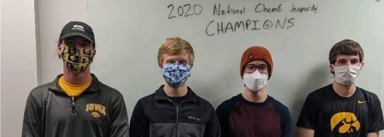 Group photo of four team members wearing masks