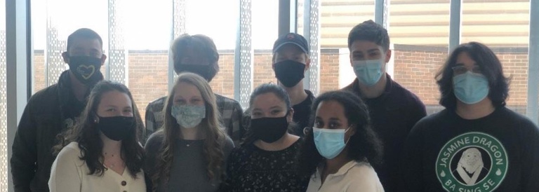 Group photo of contestants wearing masks