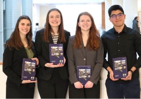 Four students pose with their awards