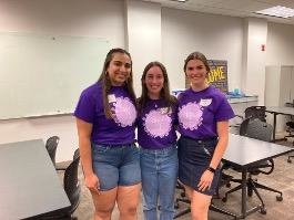 Three people pose for a photo