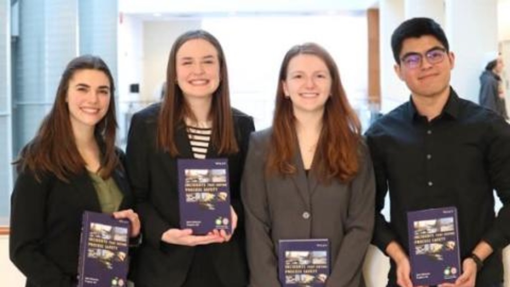 Four students pose with their awards